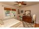 Bedroom with dresser, ceiling fan, hardwood floors, and natural lighting at 1105 Palmetto St., Georgetown, SC 29440