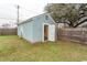 Exterior view of a shed with white trim, a partial brick foundation and a door ajar at 1105 Palmetto St., Georgetown, SC 29440