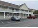 Two-story condo building with white railings and two parked cars at 113 Butkus Dr. # 3, Myrtle Beach, SC 29588