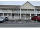 Two-story condo building with white railings and designated parking at 113 Butkus Dr. # 3, Myrtle Beach, SC 29588