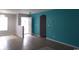 Open-concept living area with tile flooring and teal accent wall at 113 Butkus Dr. # 3, Myrtle Beach, SC 29588