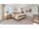 Bright bedroom features neutral tones, soft carpet, and a view of the water for a serene living space at 124 Shucking St., Myrtle Beach, SC 29588