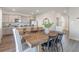 Dining area flows into the kitchen, featuring stainless steel appliances, gray cabinets and a large island at 124 Shucking St., Myrtle Beach, SC 29588