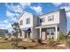 Charming two-story home featuring a mix of brick and siding under a blue sky at 124 Shucking St., Myrtle Beach, SC 29588