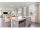 Kitchen island with dishwasher and sink, with nearby dining and living areas bathed in natural light at 124 Shucking St., Myrtle Beach, SC 29588