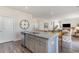 Kitchen island with sink and dishwasher overlooks the dining room and nearby living area at 124 Shucking St., Myrtle Beach, SC 29588