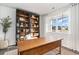 Office with a large wooden desk, bookshelf, and ample natural light from a bright window at 124 Shucking St., Myrtle Beach, SC 29588