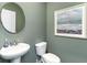 Stylish powder room with modern fixtures, a round mirror, and elegant wall art at 124 Shucking St., Myrtle Beach, SC 29588