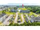 A serene aerial view of residences, a boat storage lot, and a pond against a backdrop of lush greenery at 131 Waypoint Ridge Ave. # Q-14, Little River, SC 29566