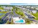 Aerial view featuring a community pool, spa, neighborhood, and clubhouse at 131 Waypoint Ridge Ave. # Q-14, Little River, SC 29566
