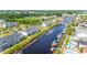 Aerial view of waterfront condos with private docks along a calm canal and various pools at 131 Waypoint Ridge Ave. # Q-14, Little River, SC 29566
