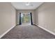 Bedroom with carpeting features balcony access with outdoor view at 131 Waypoint Ridge Ave. # Q-14, Little River, SC 29566