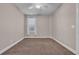 Bedroom with neutral walls and carpet, featuring a ceiling fan and window at 131 Waypoint Ridge Ave. # Q-14, Little River, SC 29566