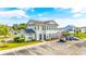 Exterior shot of the two story clubhouse featuring a large parking area at 131 Waypoint Ridge Ave. # Q-14, Little River, SC 29566