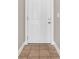 Close up of a solid white front door with a neutral wall color and a decorative tile floor at 131 Waypoint Ridge Ave. # Q-14, Little River, SC 29566