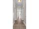 Bright hallway with wood-look flooring, white doors, and views into the unit, creating a welcoming entrance at 131 Waypoint Ridge Ave. # Q-14, Little River, SC 29566