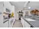 Bright kitchen featuring white appliances, light wood floors, and gray countertops at 131 Waypoint Ridge Ave. # Q-14, Little River, SC 29566