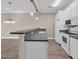 Kitchen with white appliances and cabinets, granite countertop bar separating the dining area at 131 Waypoint Ridge Ave. # Q-14, Little River, SC 29566