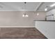 Open living area with wood-look floors, neutral paint, and bright chandelier at 131 Waypoint Ridge Ave. # Q-14, Little River, SC 29566
