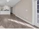 Spacious living area showcasing wood-look floors and bright kitchen at 131 Waypoint Ridge Ave. # Q-14, Little River, SC 29566