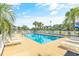 Community pool offers chaise lounges, and is surrounded by palm trees with community buildings in the background at 131 Waypoint Ridge Ave. # Q-14, Little River, SC 29566