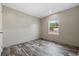 Bright bedroom features stylish wood flooring, neutral walls, and a window for natural light at 1310 Rabbit Ln., Conway, SC 29526