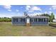 Charming single-story home with blue siding, black shutters, and a stone-accented foundation at 1310 Rabbit Ln., Conway, SC 29526