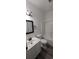 A well-lit bathroom featuring a shower, toilet, vanity, and wood-look flooring at 134 Clovis Circle, Myrtle Beach, SC 29579