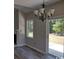 A modern dining area illuminated by a chandelier with a sliding door to the back yard at 134 Clovis Circle, Myrtle Beach, SC 29579