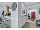 Hallway view into kitchen with breakfast bar, classic Roman numeral clock, and wood-look shelving unit at 1352 Villa Marbella Ct. # 1-304, Myrtle Beach, SC 29572