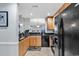 Kitchen featuring granite counters, a black refrigerator, and a kitchen pass through at 1352 Villa Marbella Ct. # 1-304, Myrtle Beach, SC 29572