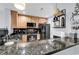 Kitchen featuring black appliances, granite counters, and bar top seating at 1352 Villa Marbella Ct. # 1-304, Myrtle Beach, SC 29572