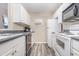 Functional kitchen with white appliances and cabinets, complemented by gray countertops and wood-look flooring at 1356 Glenns Bay Rd. # 203K, Myrtle Beach, SC 29575