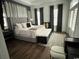 Elegant main bedroom featuring a tufted headboard, soft lighting, and dark hardwood floors at 1391 Peterson St., Myrtle Beach, SC 29577