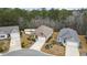 A high angle aerial view of the home showing the mature landscaping and an attached two-car garage at 1442 Chanson Ct., Little River, SC 29566