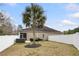 Enclosed back yard featuring a hot tub, seating, and mature palm tree at 1442 Chanson Ct., Little River, SC 29566