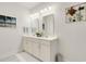 Bright bathroom features a double sink vanity with white cabinets, ample counter space, and decorative coastal accents at 1442 Chanson Ct., Little River, SC 29566