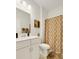 Bathroom with warm tones, a spacious vanity, and a decorative shower curtain at 1442 Chanson Ct., Little River, SC 29566