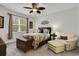 Comfortable bedroom featuring a ceiling fan, a cozy quilt, and a sitting chair near the window at 1442 Chanson Ct., Little River, SC 29566