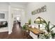 Foyer featuring hardwood floors, a 'Welcome' sign, and a view into the open-concept living and dining areas at 1442 Chanson Ct., Little River, SC 29566