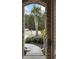 Inviting front entrance framed by stone, leading to a palm-lined yard at 1442 Chanson Ct., Little River, SC 29566