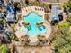 An aerial view shows a stylish community pool complete with tropical landscaping and nearby recreational areas at 1537 Beaumont Way, Myrtle Beach, SC 29577