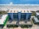 An aerial view of the building and parking deck close to the sandy beach at 1709 S Ocean Blvd. # 411, North Myrtle Beach, SC 29582