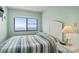 Inviting bedroom showcasing a large window with serene ocean views and stylish coastal decor at 1709 S Ocean Blvd. # 411, North Myrtle Beach, SC 29582