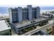 Multi-story building with a parking deck near the beach, featuring blue and gray accents at 1709 S Ocean Blvd. # 411, North Myrtle Beach, SC 29582