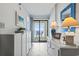 Bright hallway featuring white cabinets and a sliding glass door leading to a balcony with ocean views at 1709 S Ocean Blvd. # 411, North Myrtle Beach, SC 29582