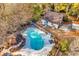 Aerial view of a backyard oasis featuring an in-ground pool, cabana, and outdoor swing at 1800 Glenns Bay Rd., Surfside Beach, SC 29575