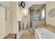 Bathroom featuring jetted tub with tile surround and glass enclosed shower at 1800 Glenns Bay Rd., Surfside Beach, SC 29575