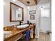 Stylish bathroom with a vessel sink on a wooden vanity, tiled floor and modern fixtures at 1800 Glenns Bay Rd., Surfside Beach, SC 29575