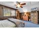 Comfortable bedroom with paneled walls, vintage furniture, and ceiling fan at 1800 Glenns Bay Rd., Surfside Beach, SC 29575